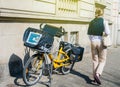 Elegant French woman walking near La Poste French bycicle parked