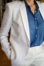 Elegant French woman wearing white jacket and white pant