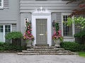 Front door of house with potted flowers Royalty Free Stock Photo