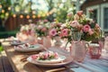 Elegant Garden Party Table Setting with Floral Decorations and Festive Lights Royalty Free Stock Photo