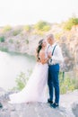 Elegant gentle stylish groom and bride near river or lake