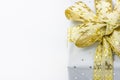 Elegant Gift Box Wrapped in Grey Silver Paper with Polka Dots Golden Ribbon. Christmas New Years Valentine Presents Shopping Sale