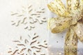 Elegant gift box wrapped in sliver paper with golden ribbon with bow on snowy background snow flakes relieves. Christmas New Years Royalty Free Stock Photo