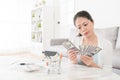 Elegant girl counting savings money in living room