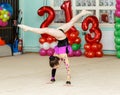 Elegant girl doing crafty splits on art gymnastics competitions