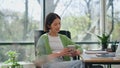 Elegant girl holding cup in creative office closeup. Lady enjoying cappuccino Royalty Free Stock Photo