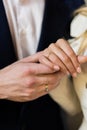 Elegant girl holds hand on her partner& x27;s hand, pointing to their wedding rings in a closeup shot. Moment of Royalty Free Stock Photo