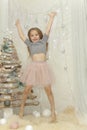 Elegant girl jumps up near a fur-tree Royalty Free Stock Photo