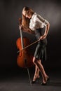 Elegant girl playing with passion on bass-viol