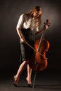 Elegant girl playing on violoncello