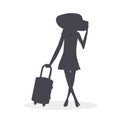 Elegant girl with a suitcase goes on a journey to adventure. She wears a beautiful dress, high heels shoes and a big straw hat. A Royalty Free Stock Photo