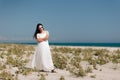 Fashion Woman with Sunglasses Wearing  Long White Dress to the Beach Royalty Free Stock Photo