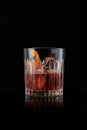 elegant glass of Bourbon Old Fashioned, on black background