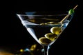 Elegant glass of dry martini with olives on a black background. Horizontal orientation Royalty Free Stock Photo