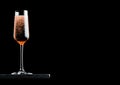 Elegant glass of pink rose champagne with bubbles on blavk marble board on black background. Space for text Royalty Free Stock Photo