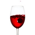 Elegant glass of red wine with splashing alcoholic beverage Royalty Free Stock Photo