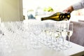 Elegant glasses with champagne standing in a row on serving tabl Royalty Free Stock Photo