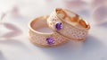 Beautiful Rose Gold Wedding Rings with Purple Gemstones, Intricate Designs Royalty Free Stock Photo