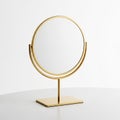 Elegant Gold Tabletop Mirror with Circular Reflective Surface and Rectangular Base golden Royalty Free Stock Photo