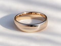 Elegant gold wedding ring on white background Royalty Free Stock Photo