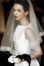 Elegant gorgeous bride holding calla bouquet, posing under veil. Royalty Free Stock Photo