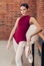 Elegant graceful dancer in red swimsuit looking at the camera