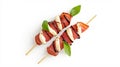 Elegant grape and prosciutto skewer with mozzarella and basil leaves for gourmet appetizers Royalty Free Stock Photo