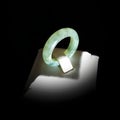 Elegant Green Jade Ring on Display with Soft Lighting and Shadows Royalty Free Stock Photo