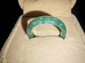 Elegant green jade ring displayed on a soft beige surface Royalty Free Stock Photo