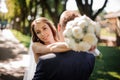 Elegant groom in a festive suit hugs a beautiful bride Royalty Free Stock Photo