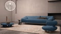 Elegant grunge living room with plaster walls and floor, fireplace. Blue sofa with pillows, carpet, fluffy armchair, side tables, Royalty Free Stock Photo