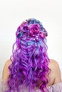 Elegant hairstyle of curls on long colored hair, styling. Bright color coloring, concept.