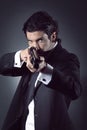 Elegant handsome gangster aiming with a shotgun Royalty Free Stock Photo