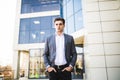 Elegant handsome young businessman while walking in front of office building Royalty Free Stock Photo