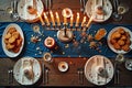 Elegant hanukkah dinner table with menorah, cookies, and candles on festive blue tablecloth Royalty Free Stock Photo