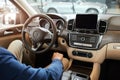 Elegant happy man in good new car in sale centre Royalty Free Stock Photo