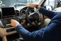 Elegant happy man in good new car in sale centre Royalty Free Stock Photo