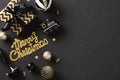 Elegant holiday flat lay composition with golden ornaments, confetti, and a chic black backdrop. Festive design for Christmas and