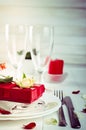 Elegant holiday table setting with red ribbon gift Royalty Free Stock Photo