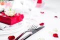 Elegant holiday table setting with red ribbon gift Royalty Free Stock Photo