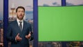 Elegant host reporting breaking news standing near green screen close up. Royalty Free Stock Photo