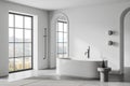 Elegant hotel bathroom interior with bathtub and panoramic window Royalty Free Stock Photo
