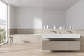 Elegant hotel bathroom interior with washbasin and tub, panoramic window Royalty Free Stock Photo