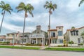 Elegant houses along road lined with tall palm trees in Long Beach California Royalty Free Stock Photo