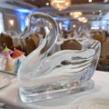 Elegant ice swan sculpture on a decorated banquet table. Royalty Free Stock Photo