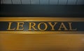 Elegant indoor sign Le Royal at wooden sealing