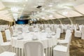 Elegant banquet hall interior prepared for feast with served tables and stage Royalty Free Stock Photo