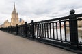 Elegant iron wrought fence of the Novoarbatskiy bridge. Famous skyscraper of the former Soviet hotel `Ukraine`. Moscow, Russia. Royalty Free Stock Photo