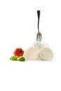 Elegant Italian dish with a DOP buffalo mozzarella from Campania with a skewered fork and tomato with basil on a whi