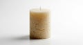 A Textured Ivory Candle Illuminating Simplicity and Serenity on a Clean White Surface, Casting Gentle Shadows Royalty Free Stock Photo
